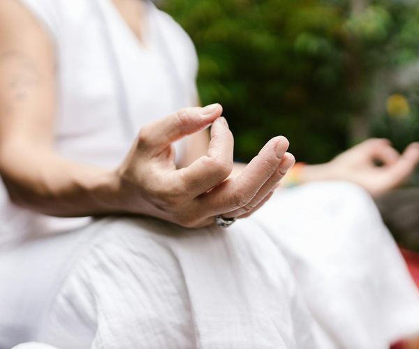 Close up of hands in a mudra position during meditation.